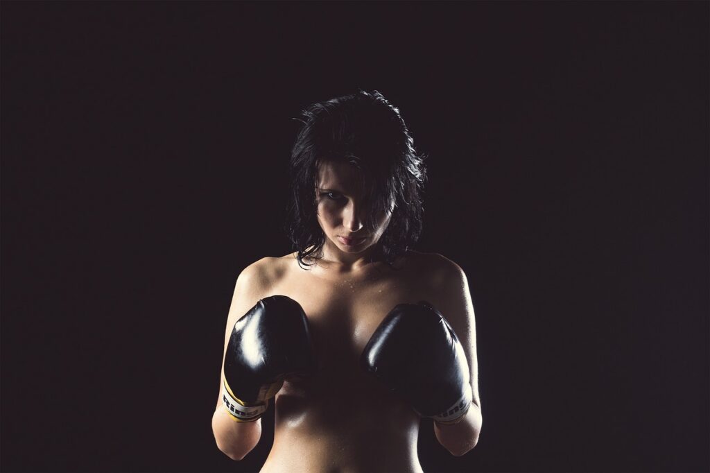 A sensual semi nude girl showing atheletic punches